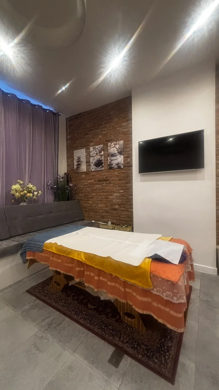 Treatment table in front of the exposed brick wall and seating area